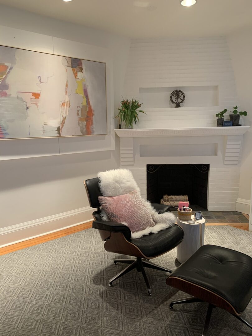 A living room with a fireplace and a chair